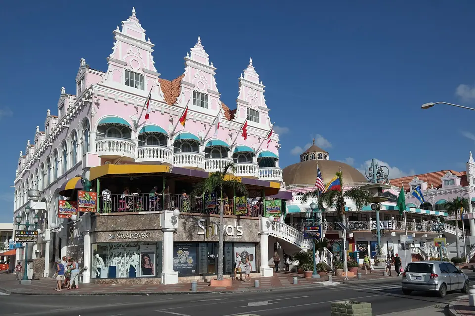 Pastel Dutch-colonial style shopping buildings with ornate gables on Lloyd G. Smith Boulevard in Oranjestad, Aruba