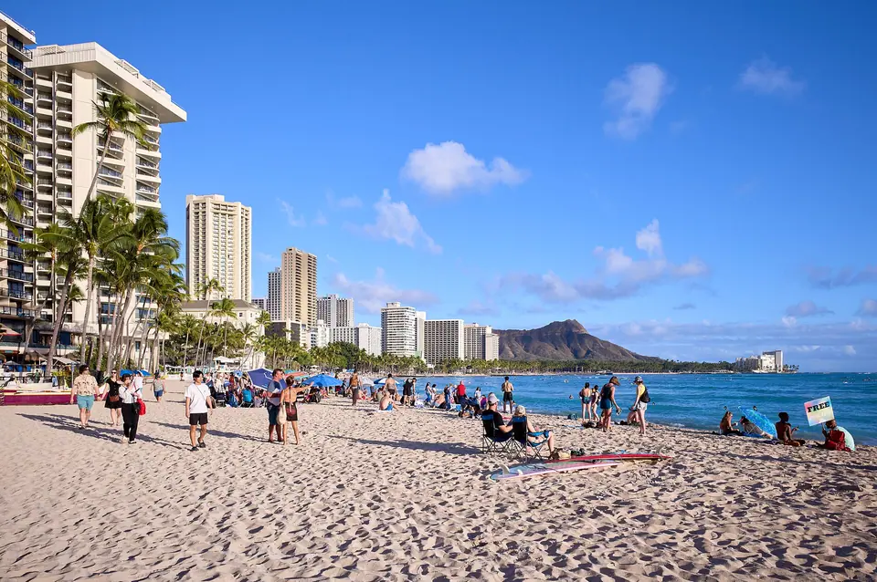 Waikiki Beach lined with hotels, with Diamond Head in the distance