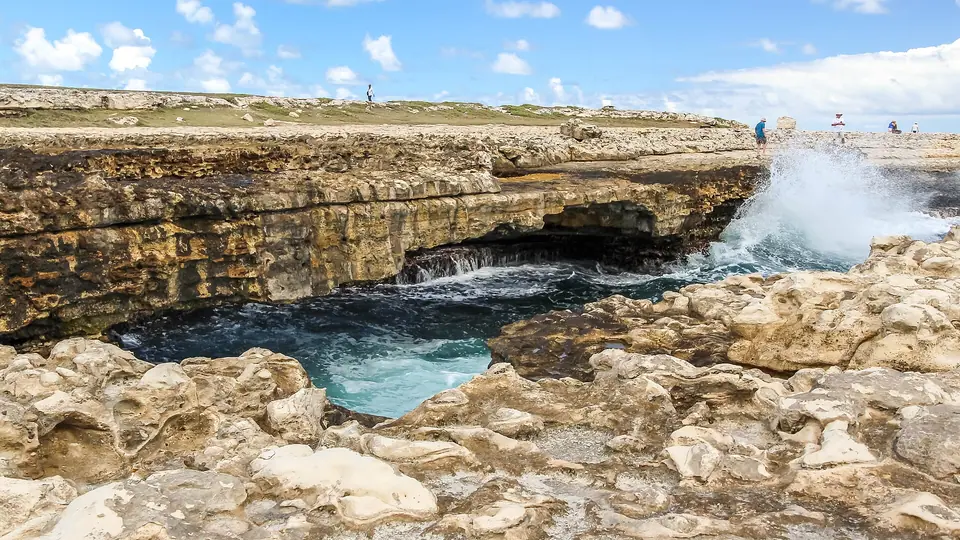 Rocky coastline and natural limestone arch at Devil's Bridge National Park, Antigua