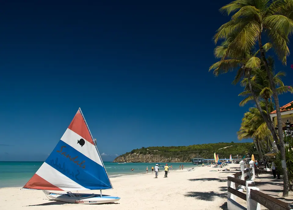 White sand and calm turquoise water at Dickenson Bay Beach in Antigua