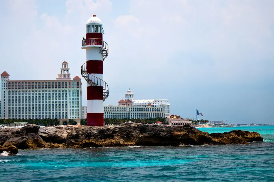 High-rise hotels lining the white-sand beach at Punta Cancun with turquoise water
