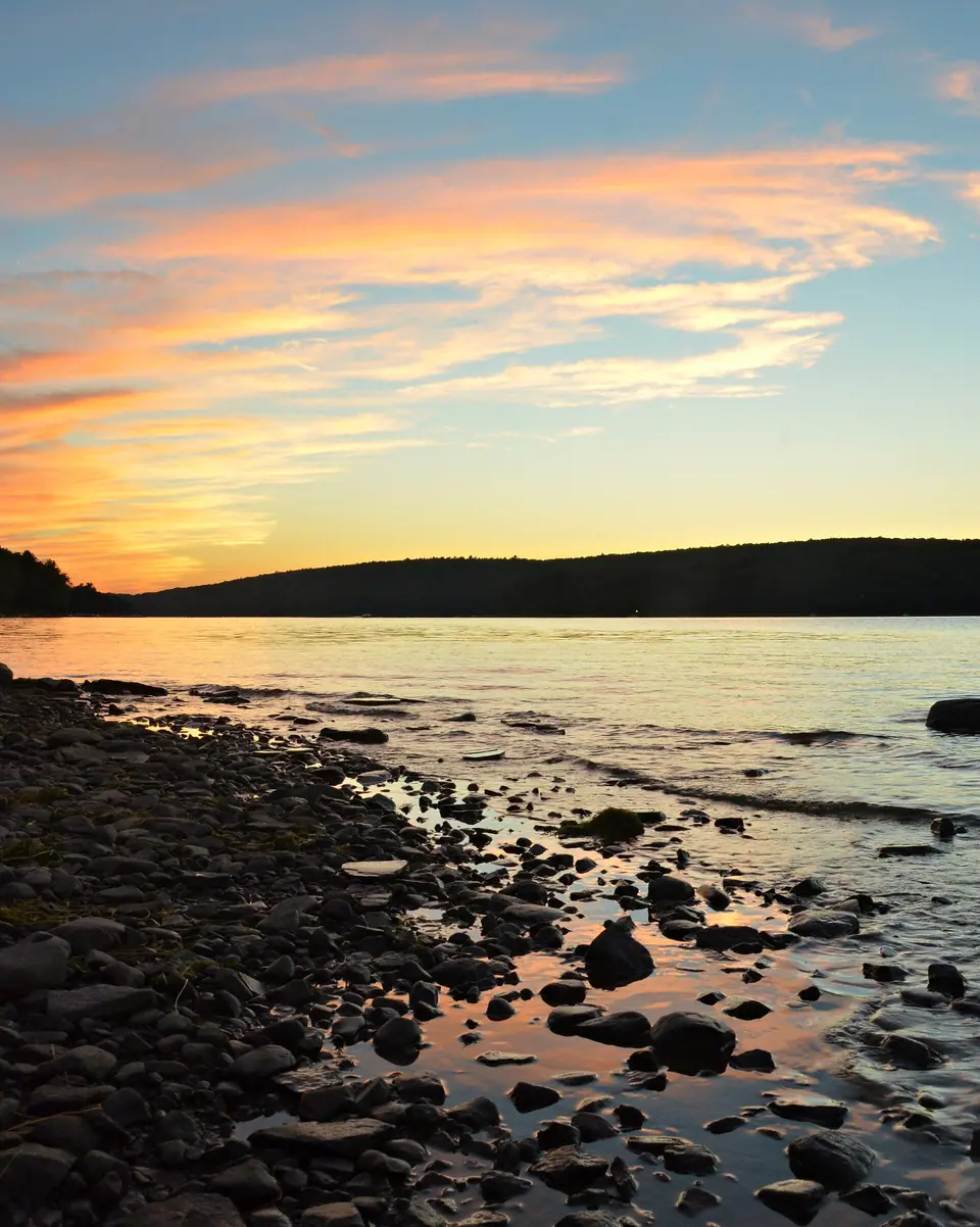 Orange sunset reflected on Lake Wallenpaupack in the Pocono Mountains of Pennsylvania