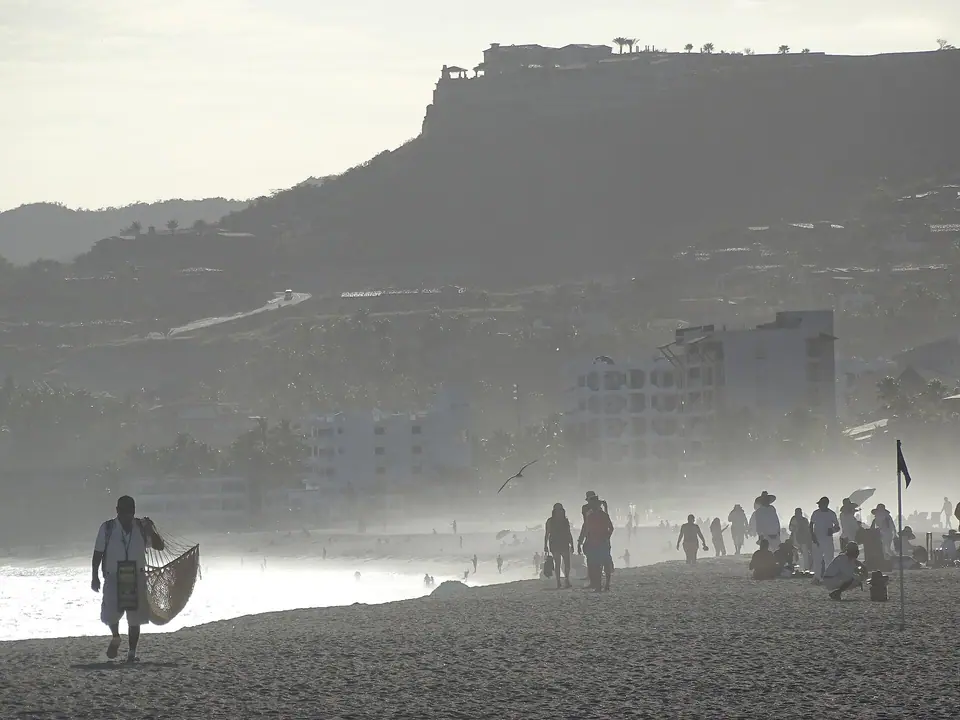 Waves breaking on the golden beach in front of resorts at San Jose del Cabo