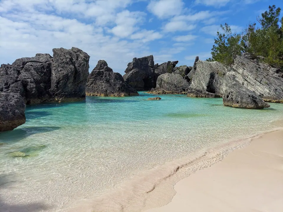 Small cove of pink-tinged sand framed by limestone rocks at Horseshoe Bay, Bermuda
