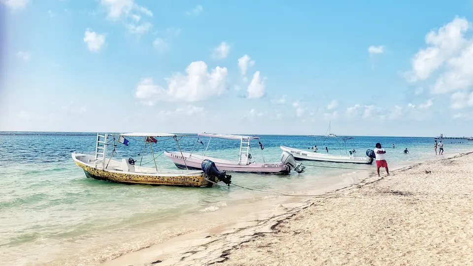 Sandy beach and calm green-blue water at Puerto Morelos, Quintana Roo