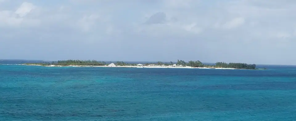 Small wooded offshore island across turquoise water, seen from Sandals Royal Bahamian in Nassau