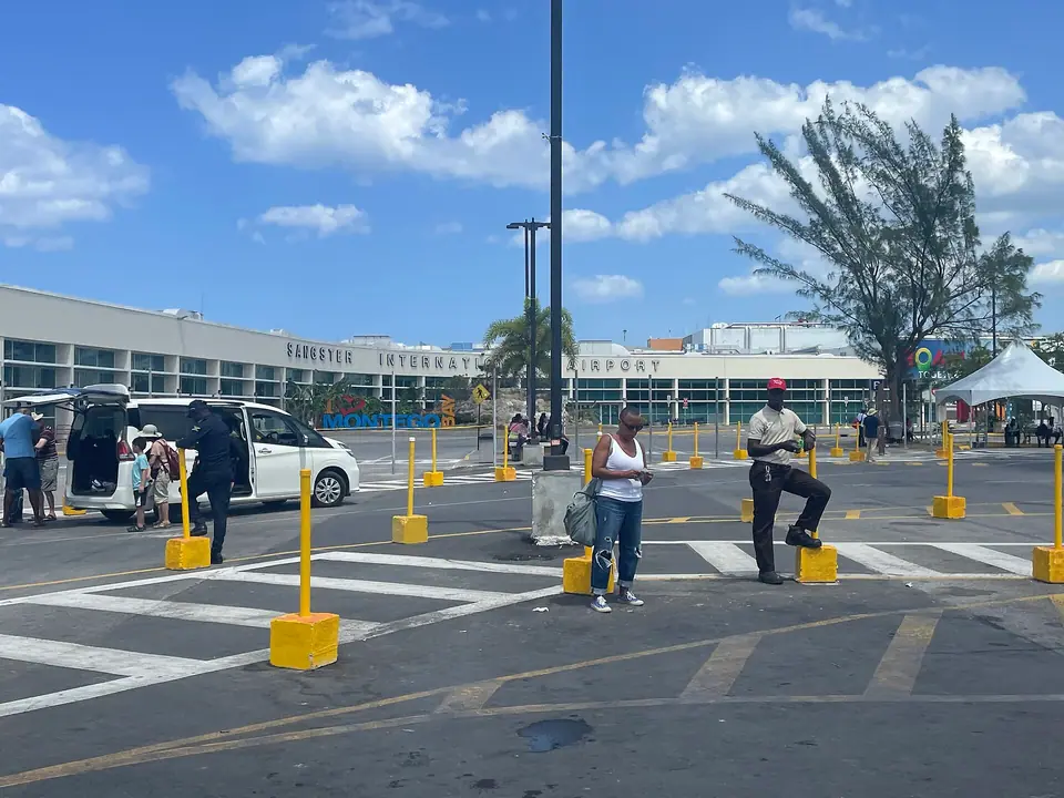 Exterior of Sangster International Airport terminal in Montego Bay seen from the public parking lot