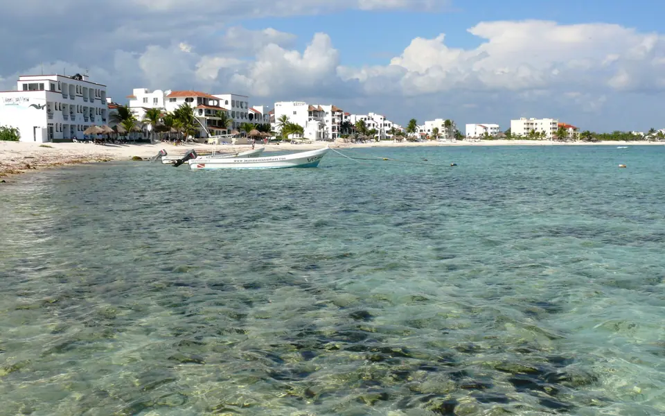 Rocky shoreline and calm water at Half Moon Bay in Akumal