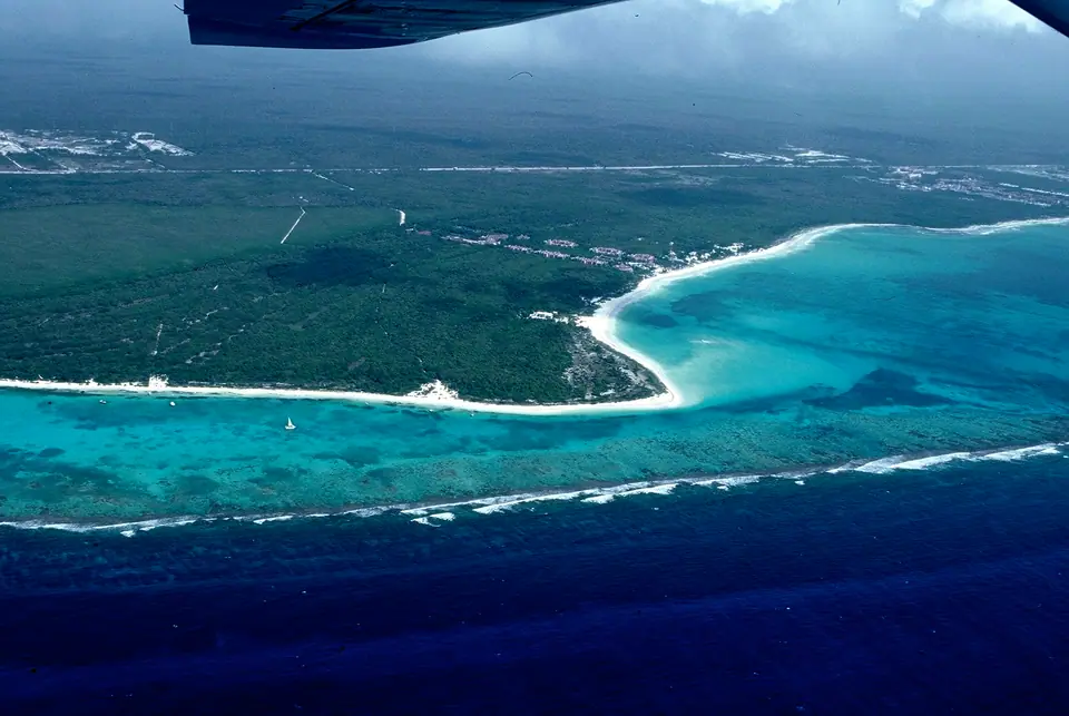 Aerial view of the Punta Maroma coastline with white sand, turquoise shallows and the reef line offshore