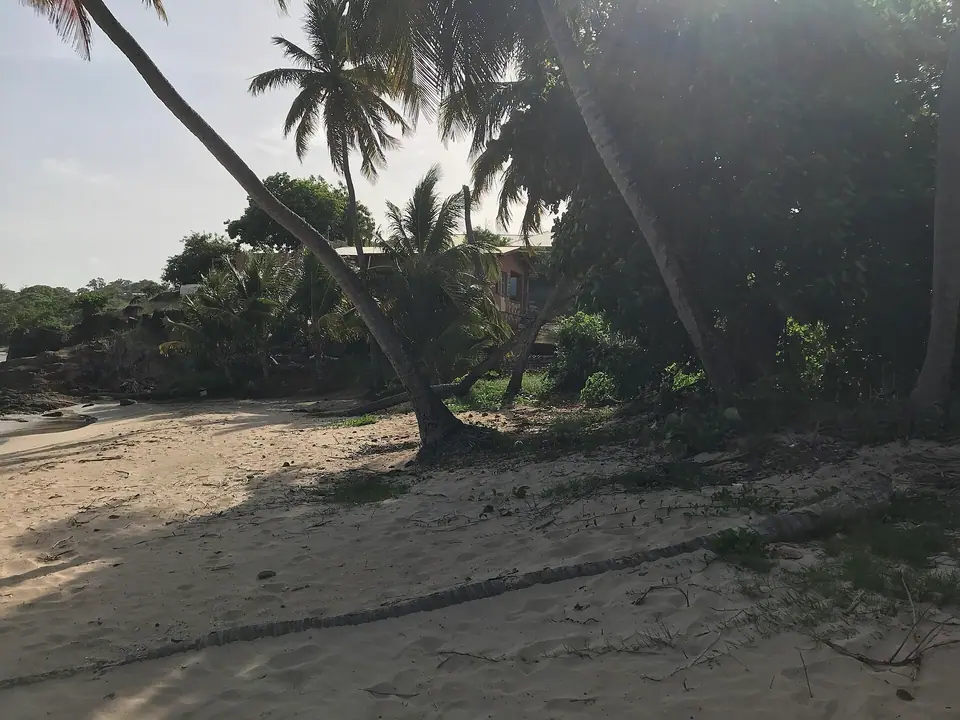 Calm bay with a sandy beach and green hills at Old Road, Antigua
