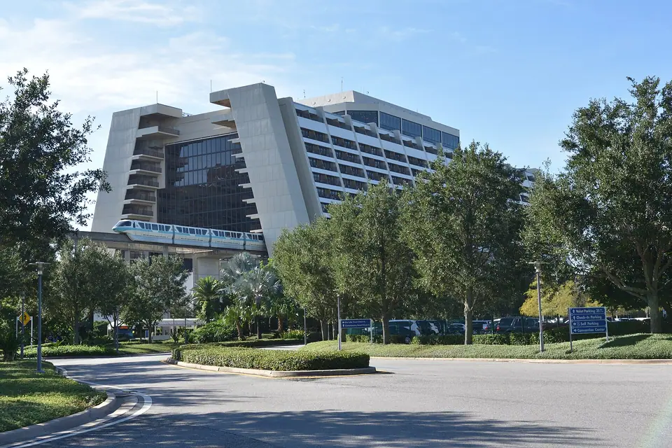 A teal-striped monorail train arriving inside the A-frame of Disney's Contemporary Resort