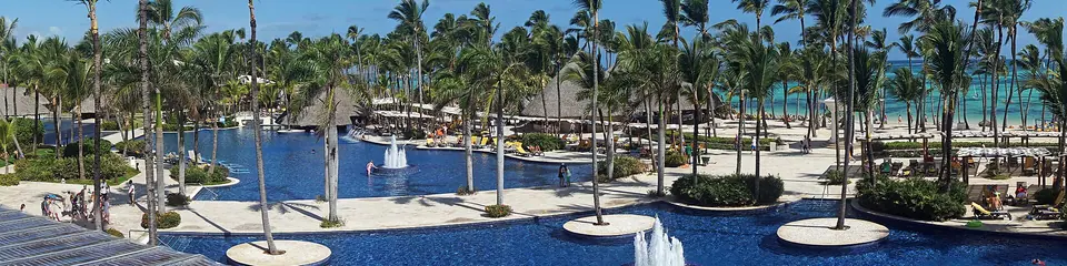 Wide panorama of the beach and palms in front of Barcelo Bavaro Palace in Punta Cana