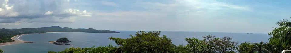 Panorama of Brasilito Bay in Guanacaste showing Playa Brasilito and Playa Conchal under blue sky
