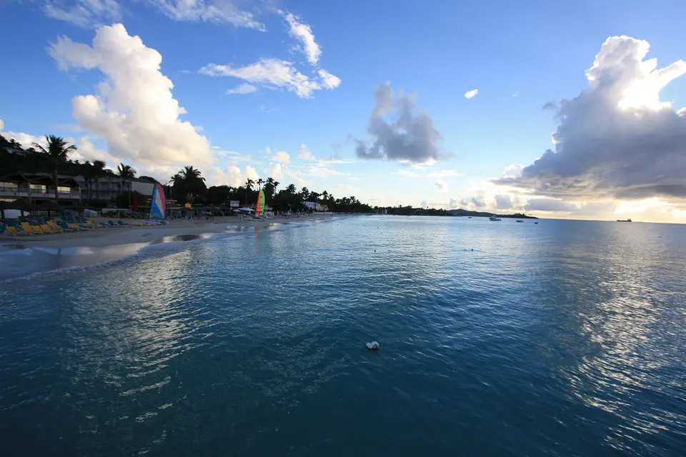 Calm turquoise water and pale sand along Dickenson Bay on Antigua's northwest coast