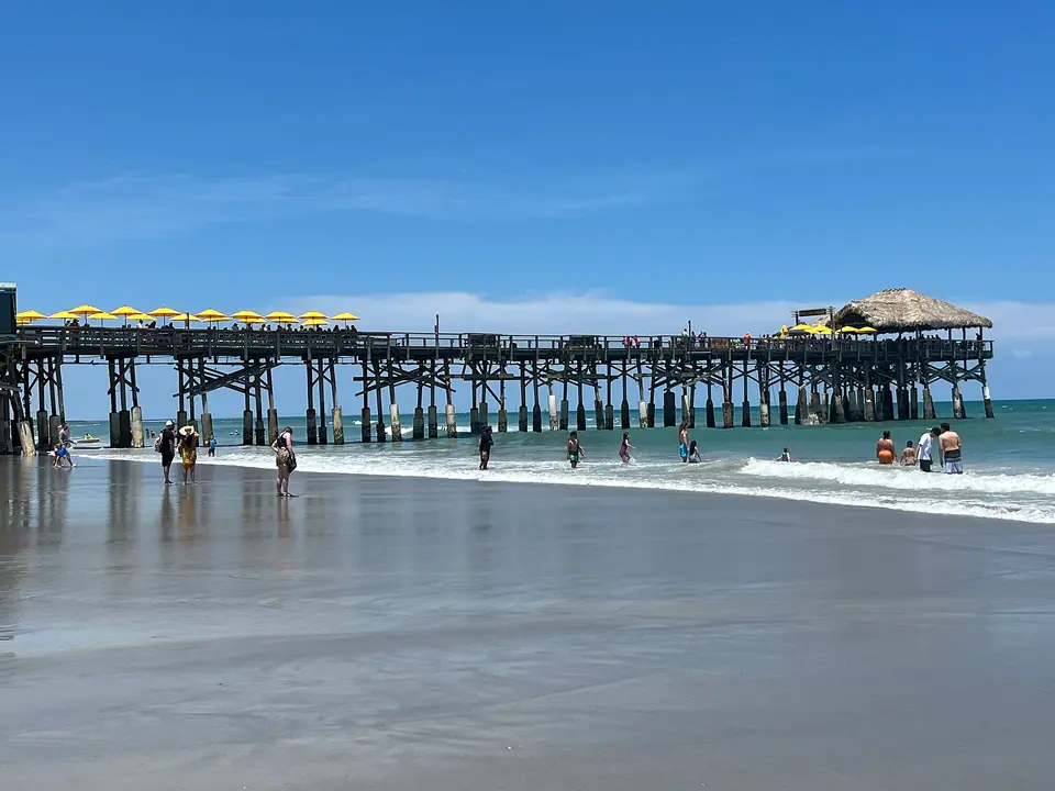 Cocoa Beach Pier stretching into the Atlantic from a wide sandy beach