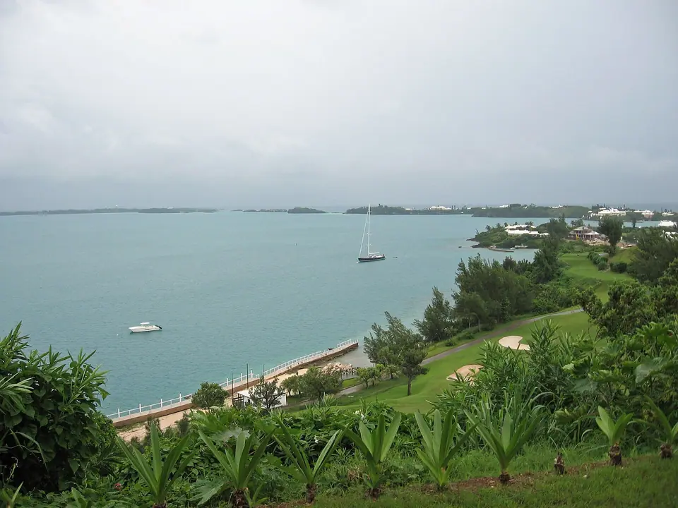 Turquoise water of Castle Harbour in Bermuda with green shoreline