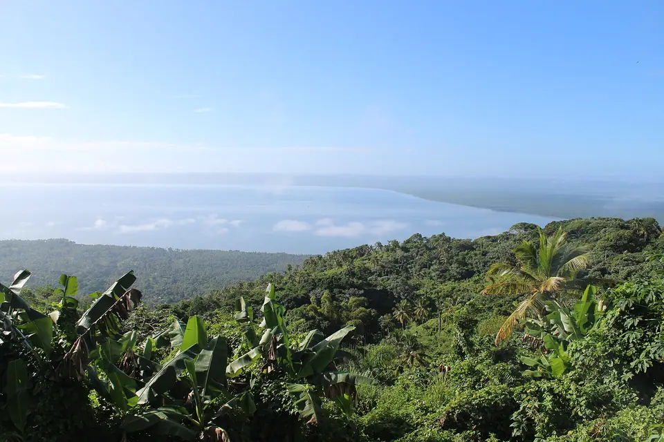 Elevated view over green hills and the blue water of Samaná Bay