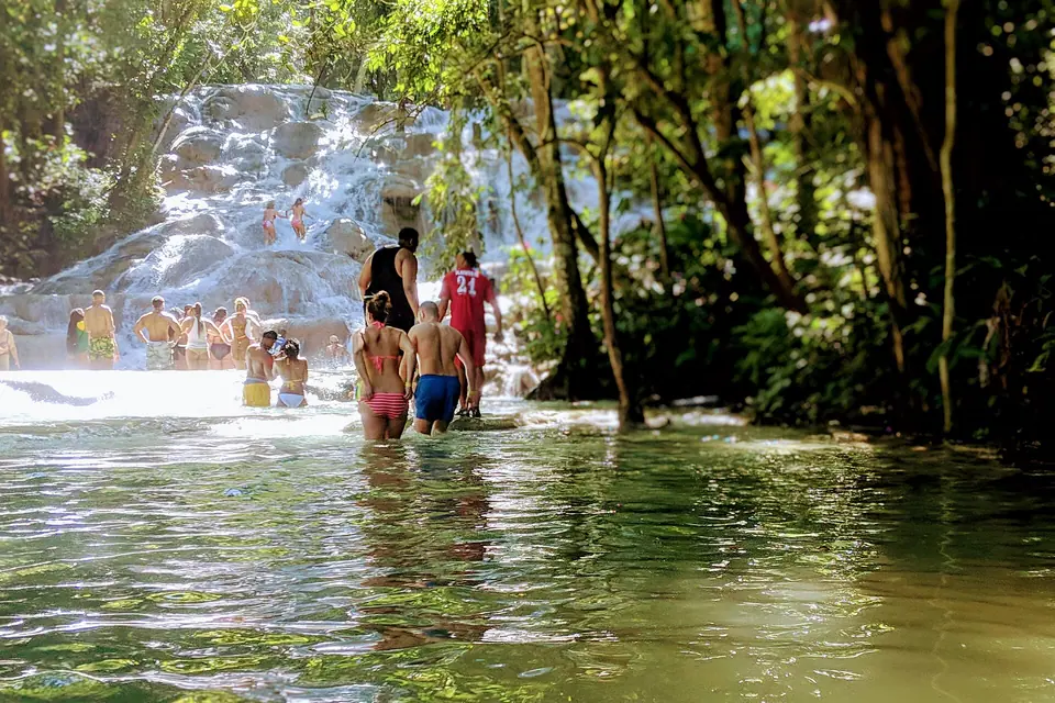 Cascading terraces of Dunn's River Falls surrounded by green forest in Ocho Rios