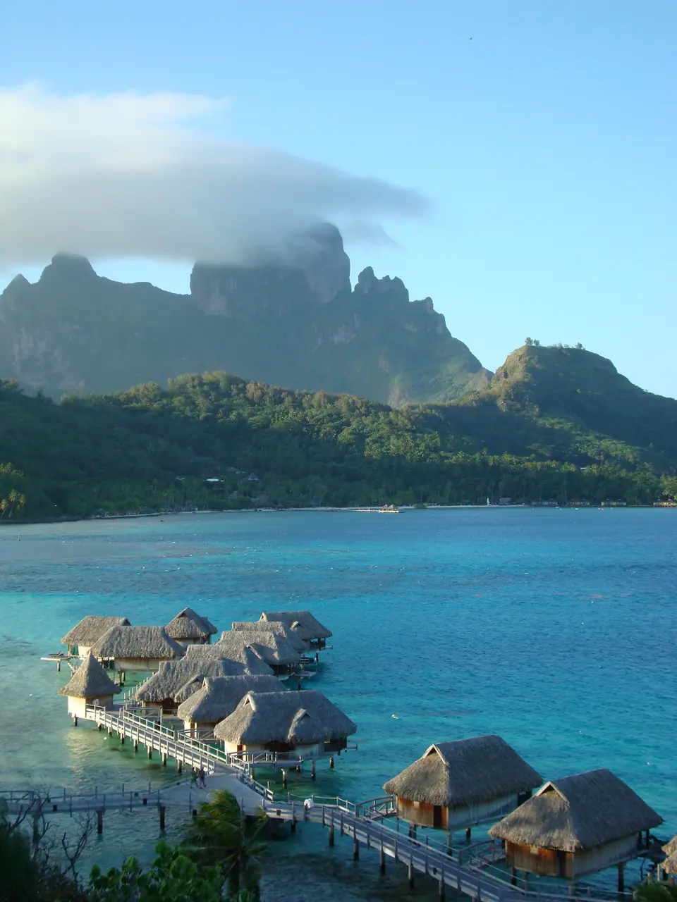 Overwater bungalows on stilts over Bora Bora's turquoise lagoon