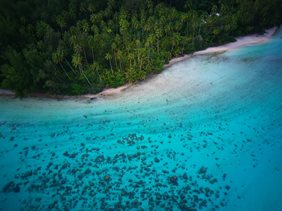 Aerial view of a turquoise lagoon and small motu off the coast of Moorea