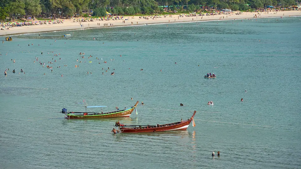 Curving sandy Kata Beach on Phuket with green hills and turquoise water