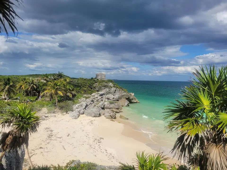 Maya ruins on a limestone cliff above a turquoise Caribbean beach at Tulum, Mexico