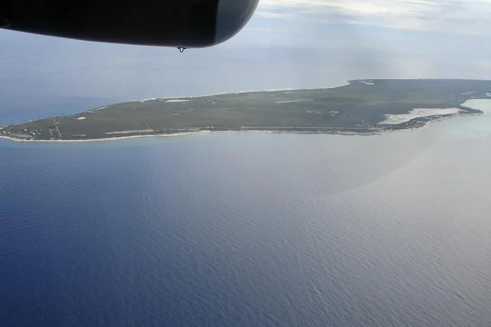 Aerial view of Little Cayman island with reef, shallow lagoon and low green interior