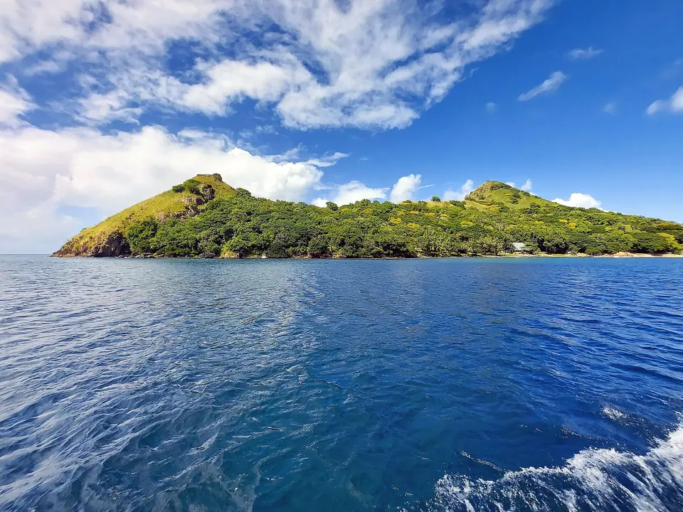 Green, hilly Pigeon Island rising from deep blue water off northern St. Lucia