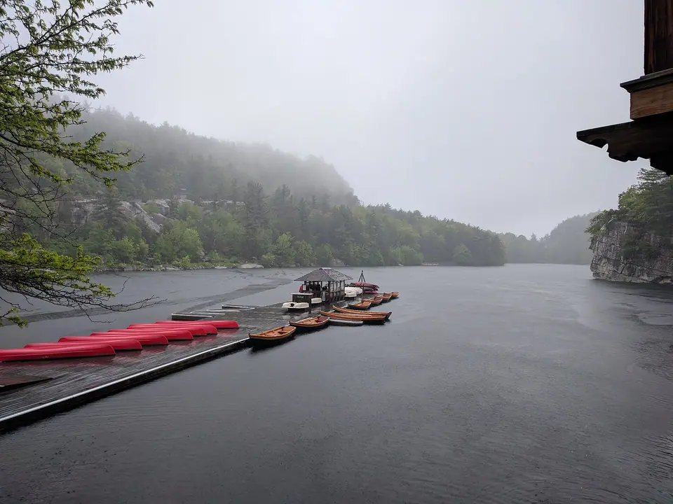 A wooden boat dock at the edge of Lake Mohonk on a cloudy day