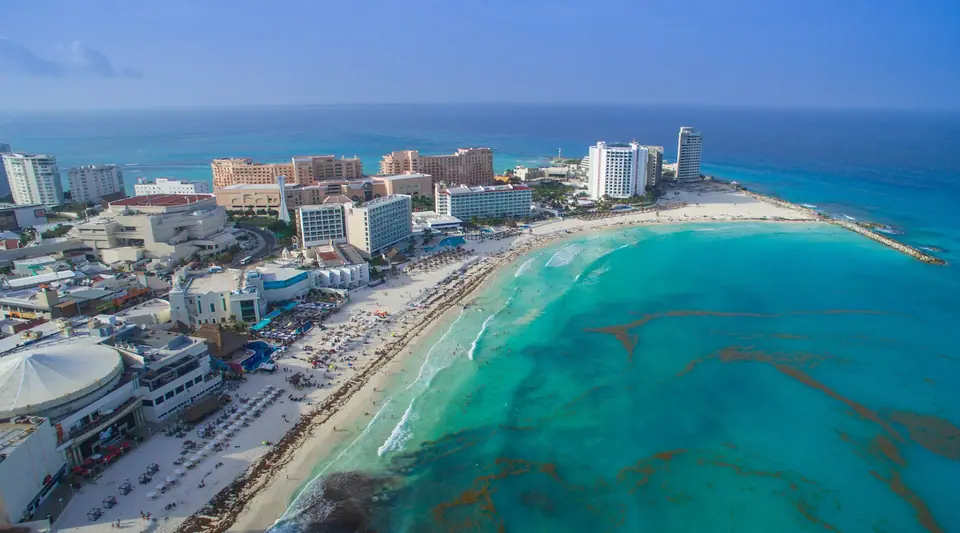 Aerial view of Cancun's Hotel Zone beachfront with hotels and turquoise water