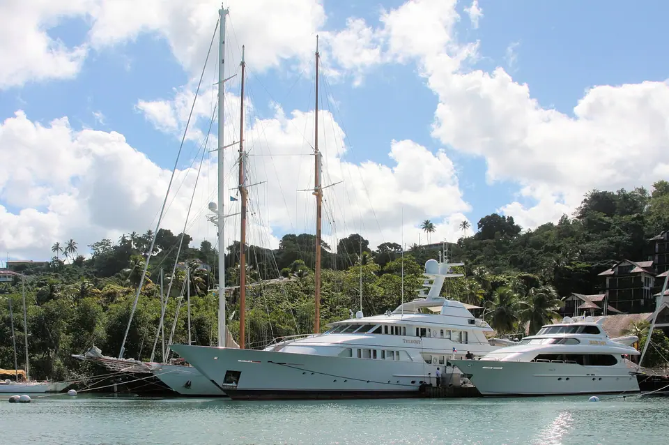 Superyachts and sailboats moored in the sheltered green inlet of Marigot Bay