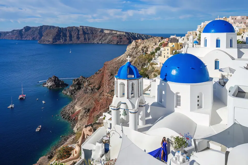 Three blue church domes in Oia, Santorini, above the caldera