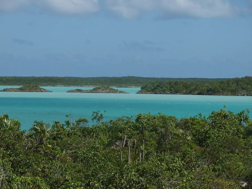 Small green islets scattered across the milky turquoise lagoon of Chalk Sound on Providenciales