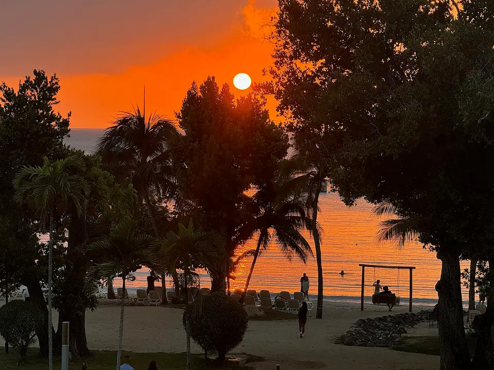 Orange sunset over the sea from a beach in Negril at the western tip of Jamaica