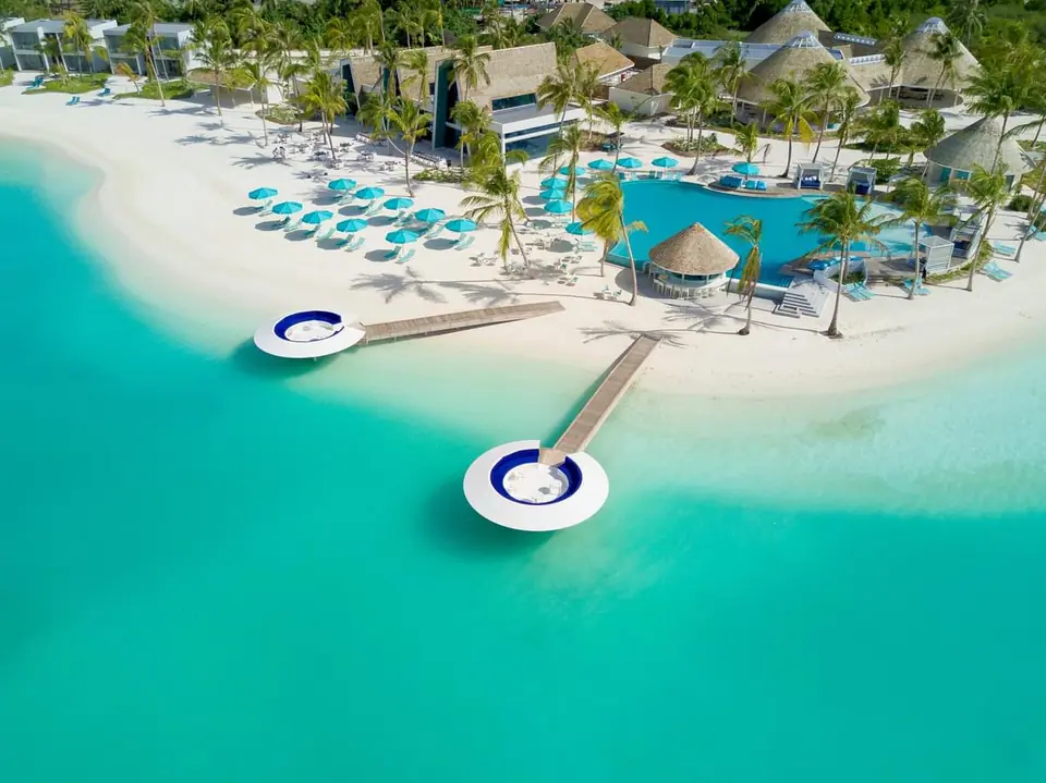 Aerial view of the Beach Club at Kandima Maldives with pool and lagoon