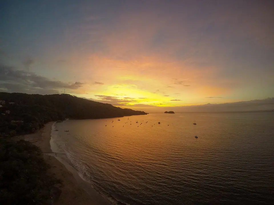 Orange sunset over the bay at Playa Hermosa in Guanacaste, Costa Rica
