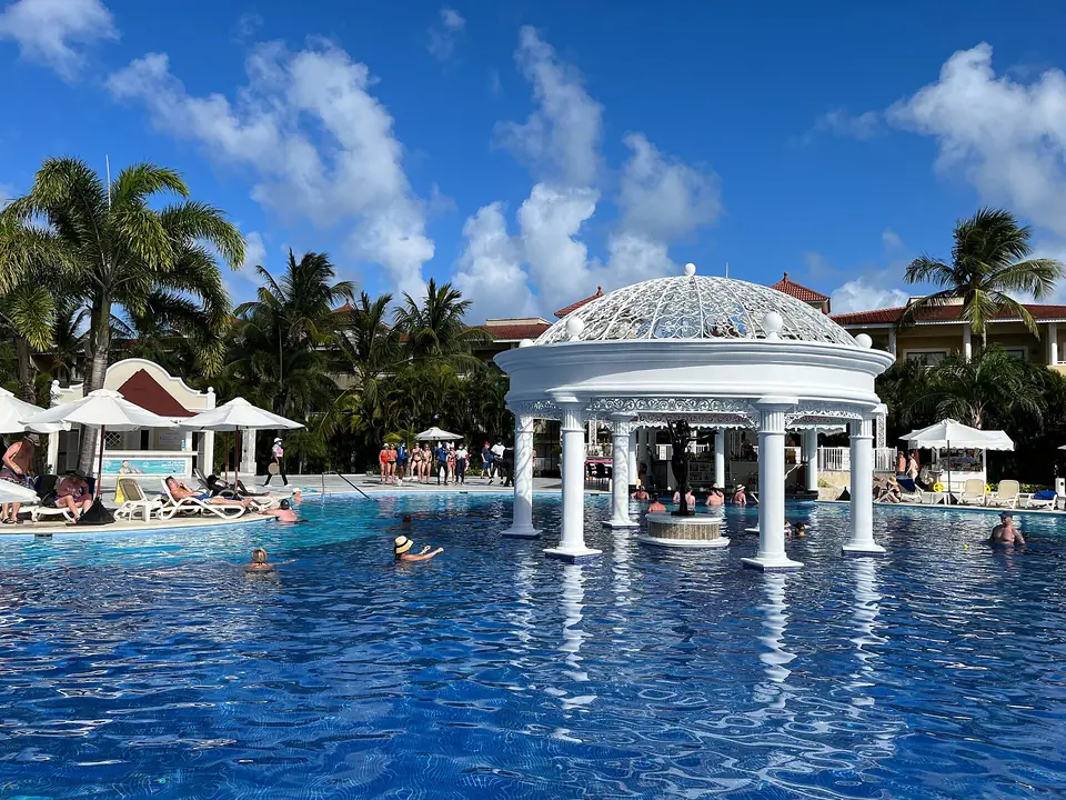 Swim-up pool bar with thatched roof at Bahia Principe Aquamarine in Punta Cana