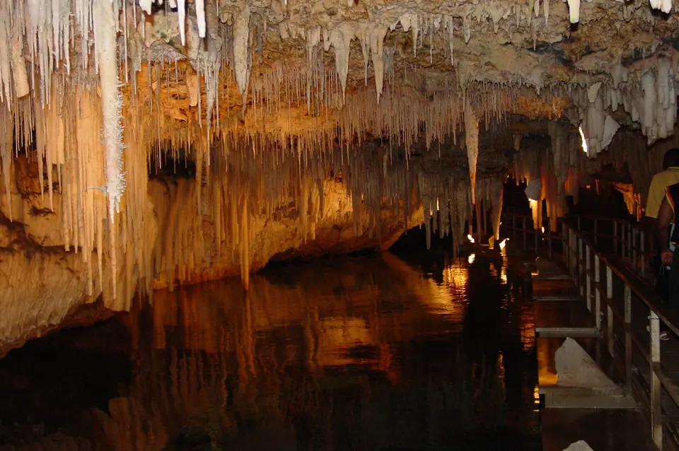 Stalactites reflected in clear water inside Crystal Cave in Hamilton Parish, Bermuda