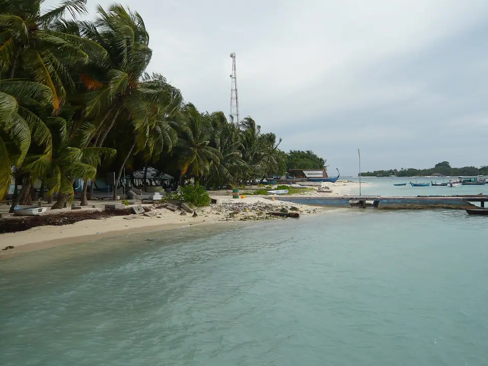 Pier on Rasdhoo, a local inhabited island near Kuramathi, with boats moored alongside