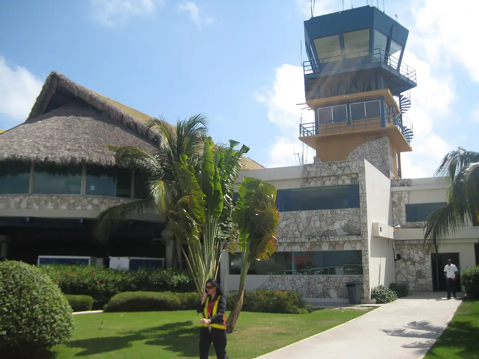 Thatched-roof terminal buildings and control tower at Punta Cana International Airport