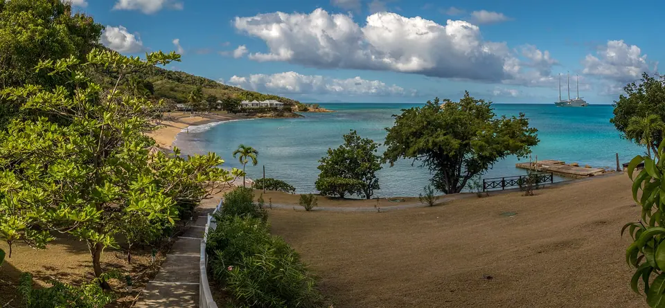 Curving white beach and calm blue water at Hawksbill Bay on Antigua's Five Islands peninsula