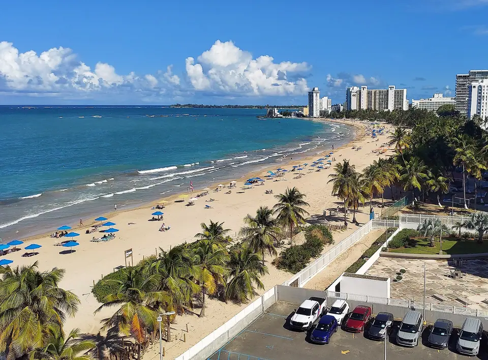 Long sandy beach at Isla Verde in Carolina looking east with hotels along the shore