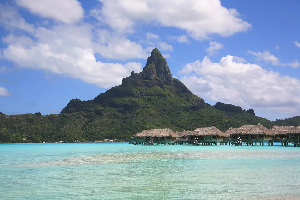 Bora Bora island and lagoon viewed from the air with the reef and motus around it