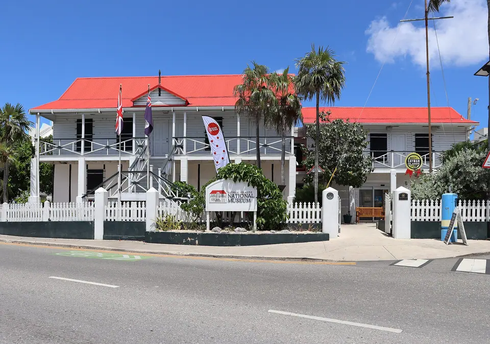 White colonial-style Cayman Islands National Museum building on the George Town waterfront