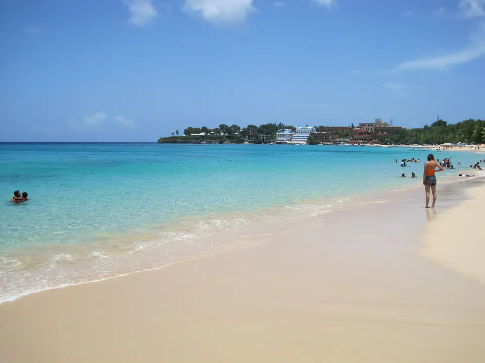 Visitors on the sand and in the water at Sosúa Beach on the north coast