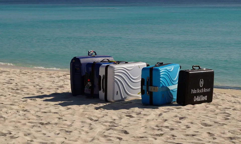 Suitcases stacked on a wooden jetty waiting for a seaplane in Lhaviyani Atoll