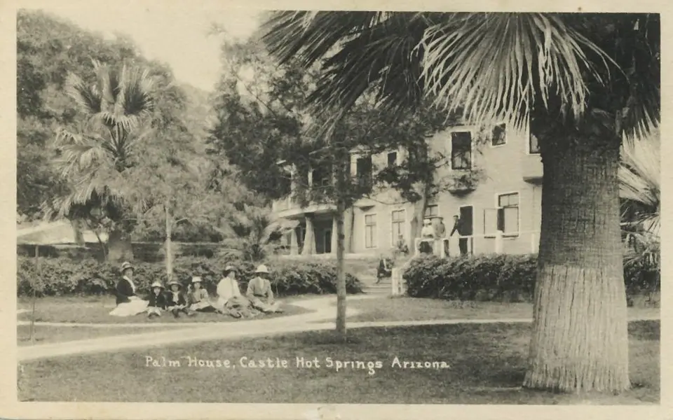 Black-and-white photo of visitors standing beside the Palm House at Castle Hot Springs in 1908