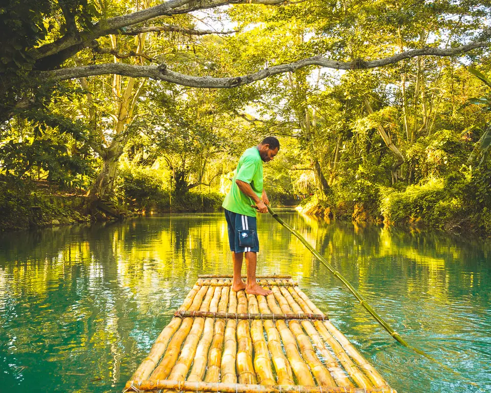 Bamboo raft carrying visitors down the green Martha Brae River in Trelawny