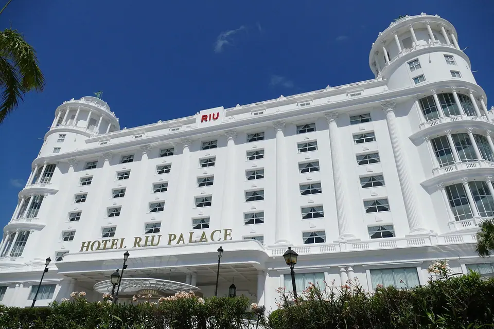 White Riu Palace hotel building in Cancun's Hotel Zone with palm trees