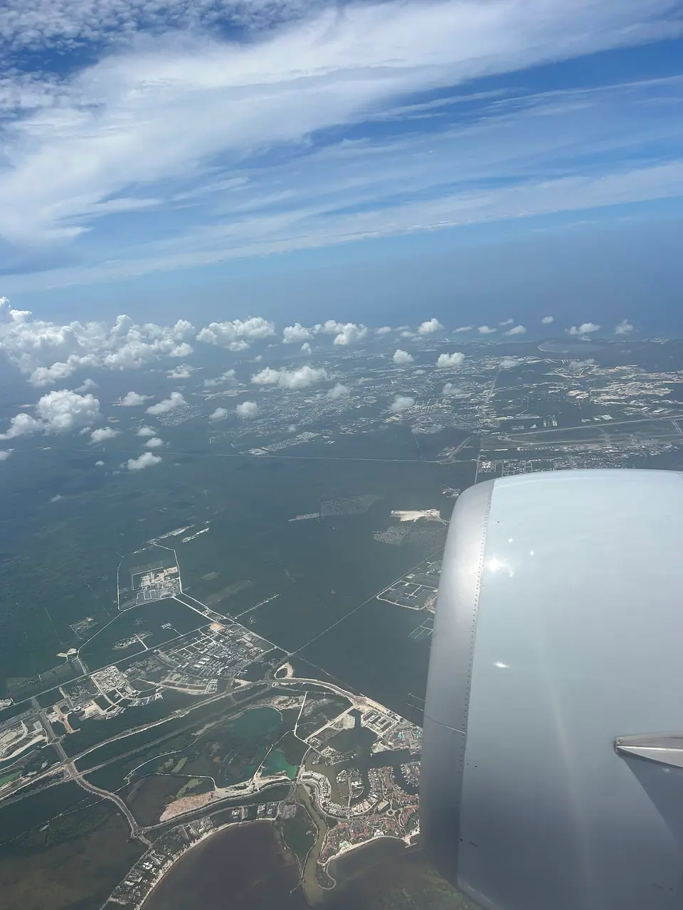 Aerial view of the Cap Cana coastline and development seen from an airplane window